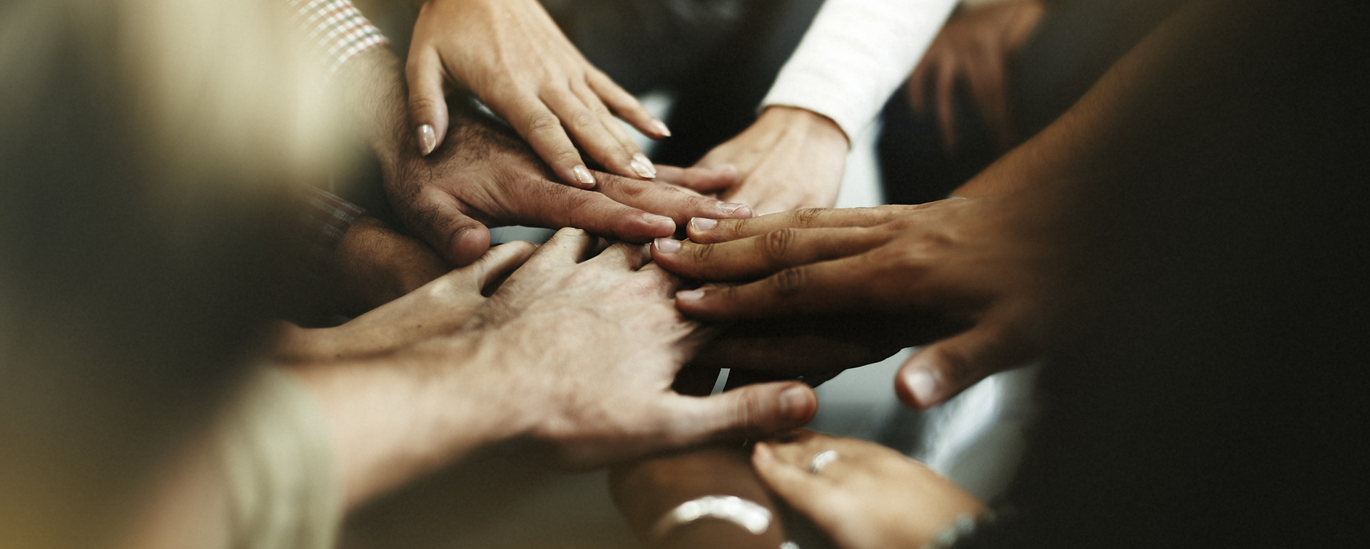 Closeup diverse people joining their hands