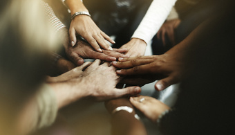Closeup diverse people joining their hands